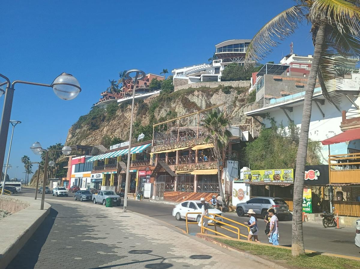 The Malecon in Mazatlan with a clifftop mansion overlooking the ocean